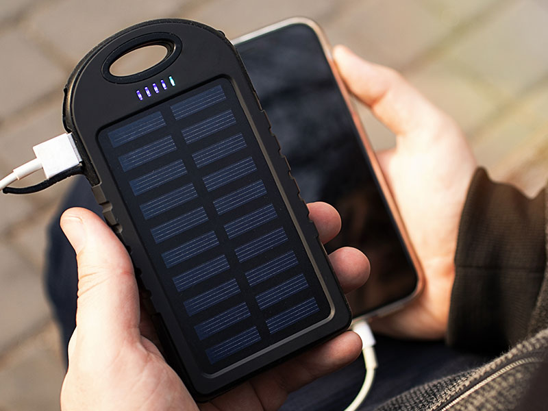 portable solar power bank charging under sun light