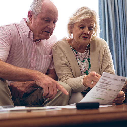 Couple looking at reduced electricity bill