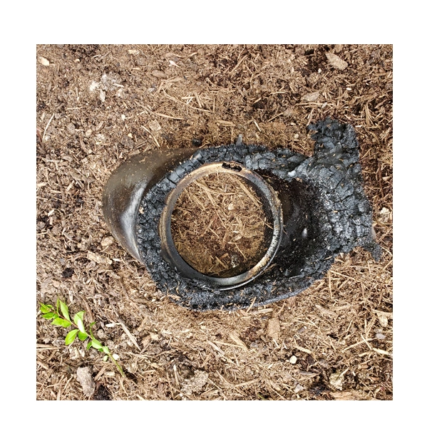 burned outdoor light on a mulch